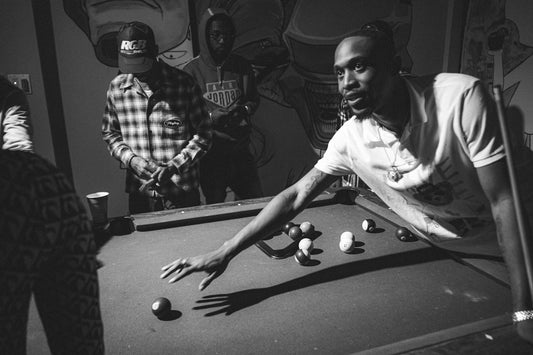 a group of men playing a game of pool