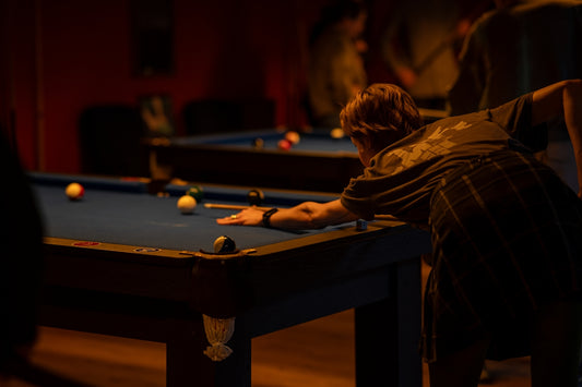 a man is playing a game of pool