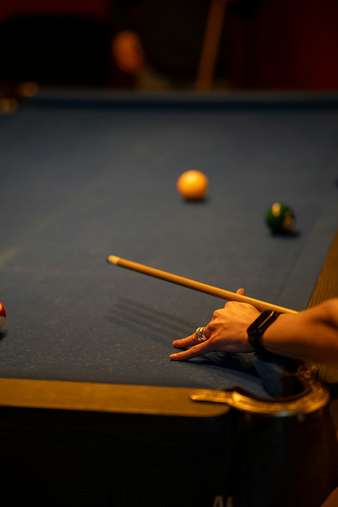 a pool table with a pool cue and balls on it