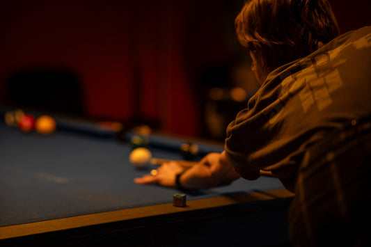 a man is playing a game of pool