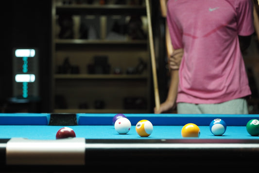A man standing in front of a pool table