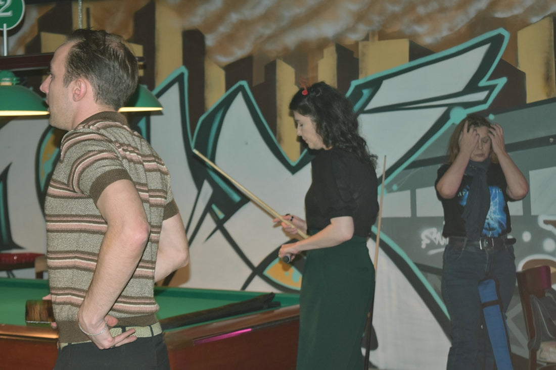 People are playing pool in a bar.