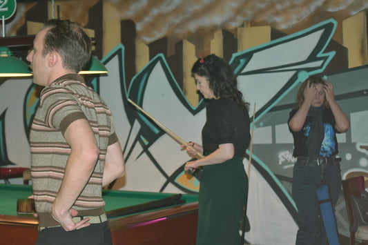 People are playing pool in a bar.